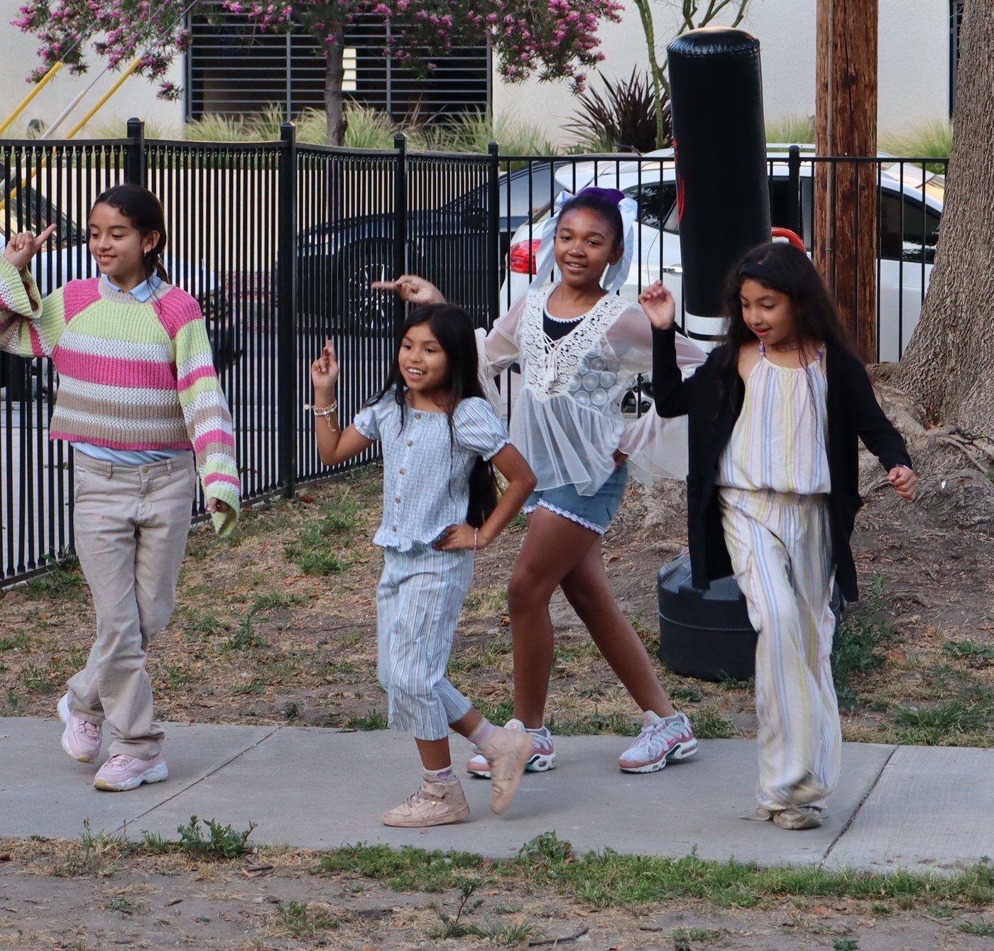 Four students mid-move in a dance routine at the showcase